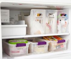 an open refrigerator with plastic containers on the shelves