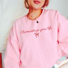 Get ready to be OBSESSED with your new Romanticize Your Life sweatshirt. It's the cutest and most trendy way to emit all those coquette vibes! This is the perfect romantic crewneck! Great as a gift! * C O L O R * I N F O* ✺ This design is printed in red on Light Pink, White, Ash, and Sand ✺This design is printed in pink on Heliconia * Q U I C K * F A C T S * ✺ 50% Cotton, 50% Polyester ✺ Wash and dry normally inside out (on cool for best results) * S I Z I N G * ✺Gildan 18000 ✺ Sizing is unisex so runs like men's, though not overly large ✺ Most women find their typical size works best, since they are meant to fit a touch loose ✺ See size guide in photos for more info * S H I P P I N G * T I M E S * ✺ Our items are individually made with love for each of our buyers. Because of this, our pro San Jose, Romantic Sweater, Coquette Sweatshirt, Coquette Vibes, Coquette Clothes, Romanticize Your Life, Coquette Shirt, Shirt Coquette, Happy Tshirt