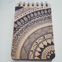 a spiral notebook with an intricate design on it