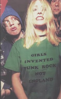 two people standing next to each other wearing t - shirts that say girls invented punk rock not england