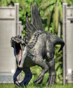 a statue of a dinosaur with its mouth open