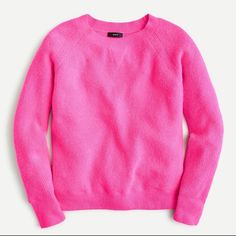 a bright pink sweater on a white background