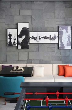 a living room with couches, tables and pictures on the wall above them in different colors