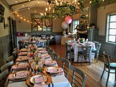 a long table set up with plates and place settings