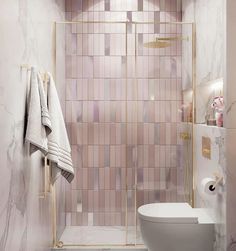 a white toilet sitting in a bathroom next to a walk in shower and tiled walls