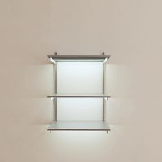 a white shelf with two shelves on each side and a light above it in the middle