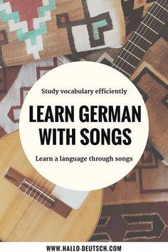 an ukulele guitar with the words learn german with songs on it, in front of