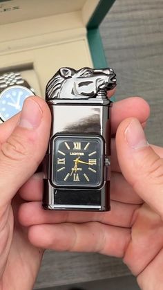 a person holding a lighter shaped like a bear with roman numerals on it