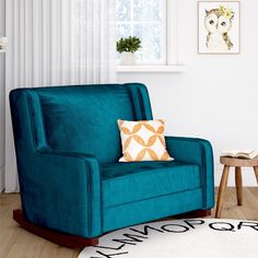 a living room with a blue chair and white rug