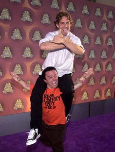 two men are doing tricks on the purple carpet