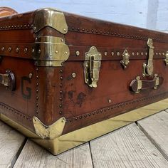 an old trunk sitting on top of a wooden floor