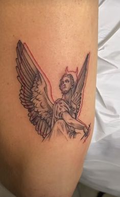 an angel tattoo on the back of a woman's leg