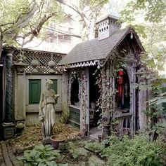 an old house with a statue in the yard