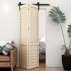 a living room with a couch and a tall white wooden door in the middle of it