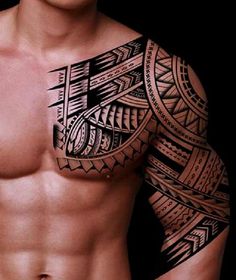 a man's chest and arm with an intricate tattoo design on the upper half