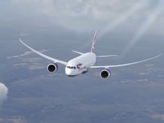 an airplane is flying in the sky above some clouds