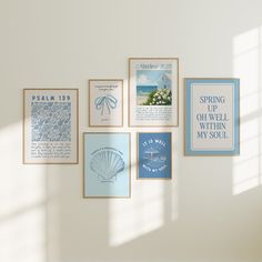 there are many framed pictures on the wall with words and symbols above them, including seashells