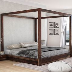 a bedroom with a four post bed and white walls