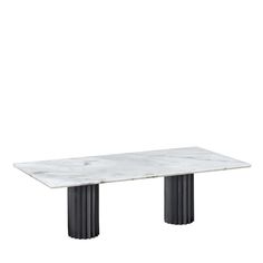 a white marble table with black columns