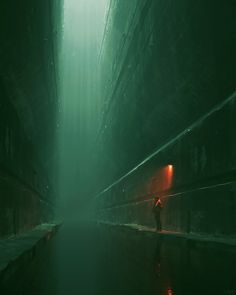 a person standing in the middle of a dark alley