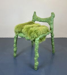 a green chair sitting on top of a blue floor