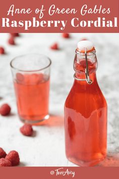 a bottle of raspberry cordial next to some raspberries