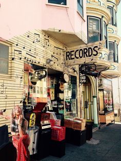 an old record store with musical notes on the side of it's front door