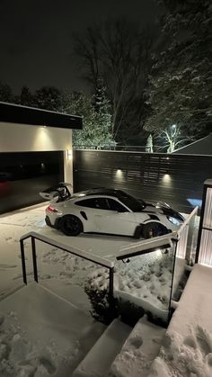 two cars parked in the snow at night