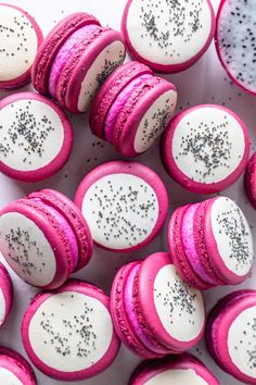 pink and white macaroons with sprinkles on them
