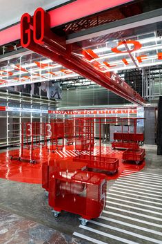 the inside of an industrial building with red and white lines on the floor, along with metal racks