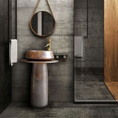 a bathroom with a sink, mirror and towel dispenser