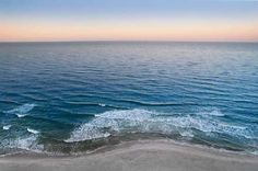 an aerial view of the ocean at sunset