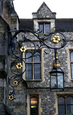 an old stone building with a street light attached to it