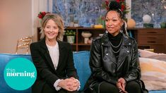 two women sitting on a blue couch in front of a christmas tree with the words this morning