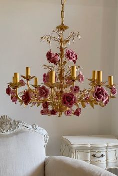 a chandelier with pink flowers hanging from it