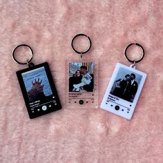 two key chains with pictures on them are laying next to each other and one has an mp3 player attached to it