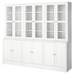 a white bookcase with glass doors on the top and bottom shelves, in front of a white background