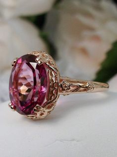 3.4ct. Natural Pink Topaz Rose Gold plated Sterling Silver Ring Edward Design#D70z (smaller version) This filigree ring is an Edwardian antique reproduction in rose gold plated sterling silver set with a 3.4 carat Natural Pink Topaz gemstone solitaire. This full cut oval gem is 12mm x 10mm. This ring sits 7mm off the finger. The inside of the band is marked 925 for sterling silver. Notice the beautiful floral leaf design of the silver filigree setting and the etched band. This ring is part of ou Rose Gold Gemstone Ring, Pink Gem Ring, Gem Engagement Rings, Rose Gold Earrings Wedding, Pink Topaz Ring, Pink Gold Rings, Pink Stone Rings, Edwardian Jewelry, Pink Topaz