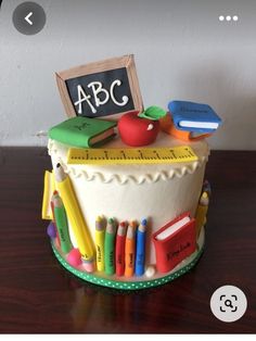 a cake that is decorated to look like an abc teacher's desk with school supplies on top