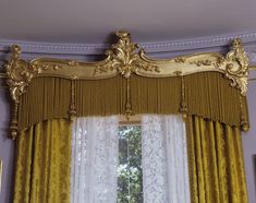 the curtains in this room are yellow and white with gold trimmings on them