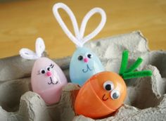 three decorated eggs in an egg carton