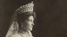 an old black and white photo of a woman wearing a tiara