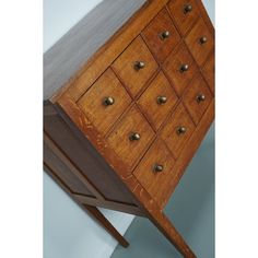 a wooden dresser with many drawers and knobs