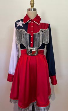 You won't be lonely for long in the lone star dress! Made to order a line pearl snap dress features rhinestone fringe and silver metallic fringe. Dress is made out of a high quality satin and Texas flags. Dress comes complete with a matching satin belt with oversized Texas belt buckle. Concho Belt With Dress, Western Homecoming Dresses, Texas Dress, Texas Belt Buckle, Cowgirl Dress, Star Pearl, Moon Projects, Texas Fashion, Flag Dress