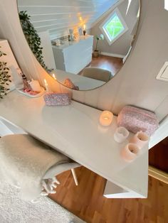 there is a vanity with candles on the counter and a mirror in the corner above it