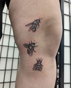 three bees tattoo on the back of a woman's thigh