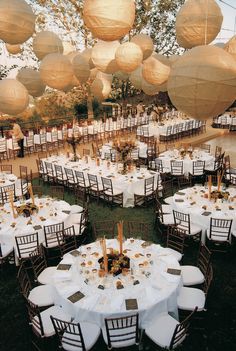 tables and chairs are set up with paper lanterns