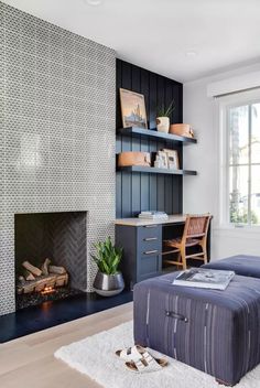 a living room with a couch, fireplace and bookshelf