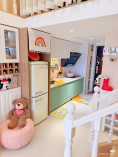 there is a teddy bear sitting on a bean bag chair in this dollhouse kitchen
