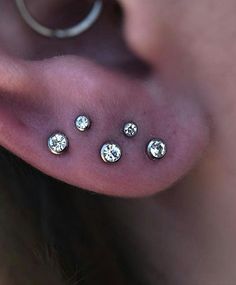 a person with four piercings on their ear